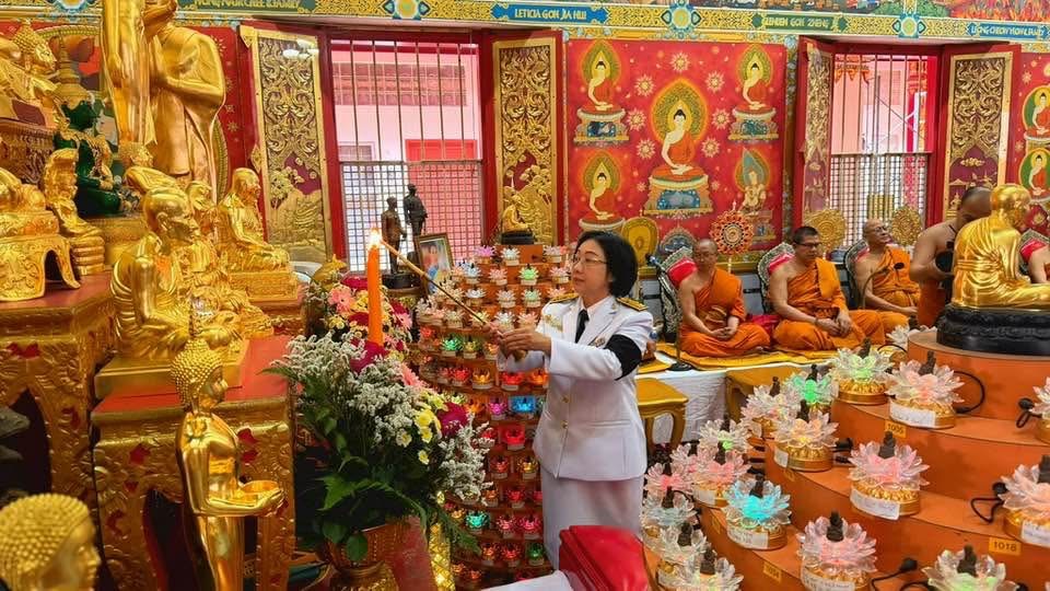 Royal Thai Embassy representative making a devotional offering during the Kathina observance